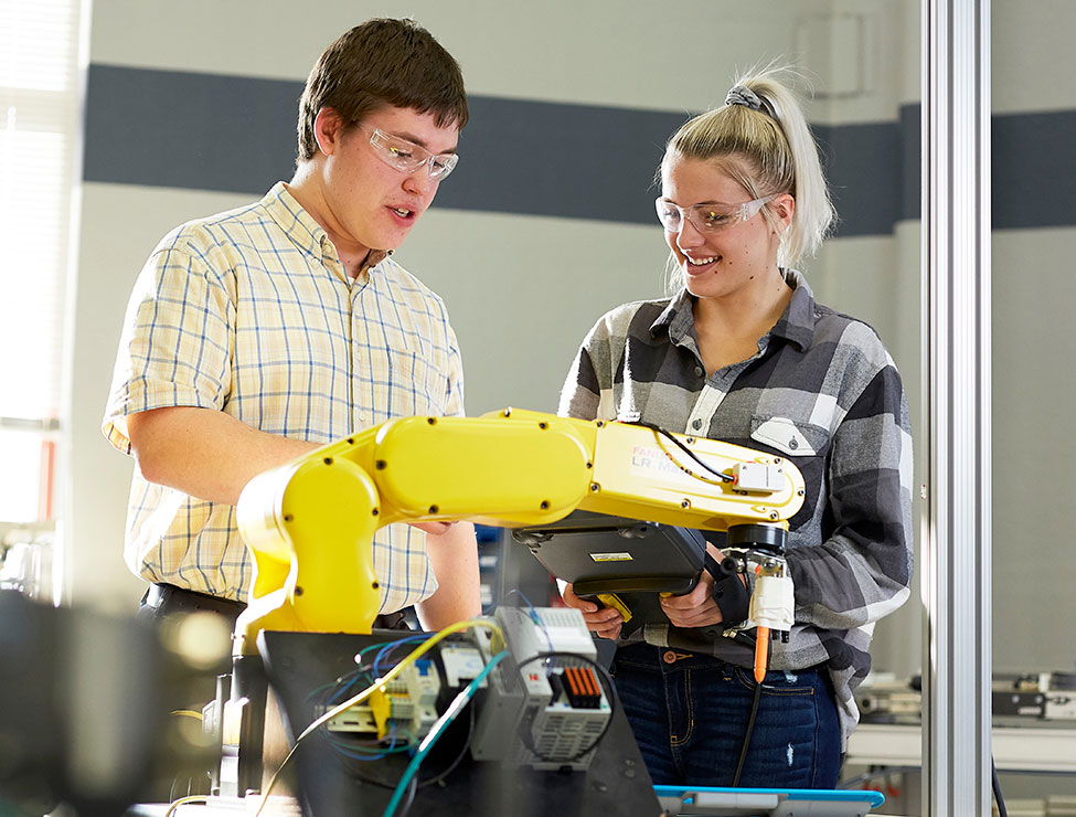 Students working on robotic machine