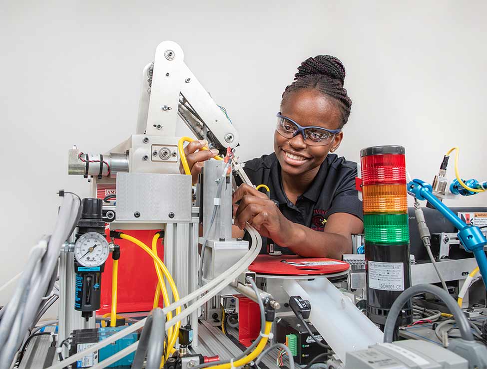 Student working on machine arm