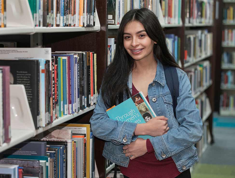Student smiling in campus library