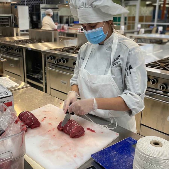 Chef prepping meat for cooking