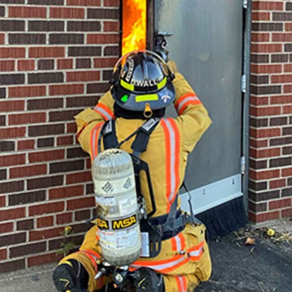 Firefighter opening door