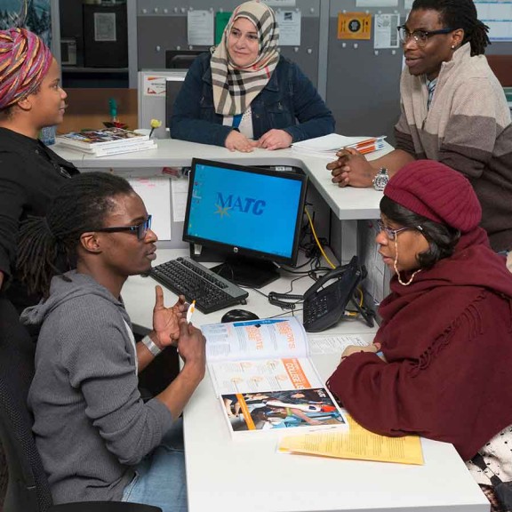Students and staff in campus office