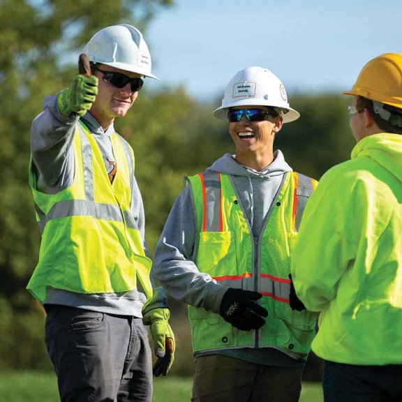 Construction workers laughing together outside