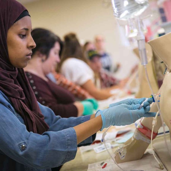 Medical students practicing on mannequins