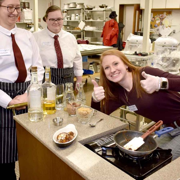 Culinary student smiling with final dish