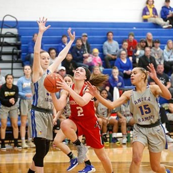 Women playing a college basketball game
